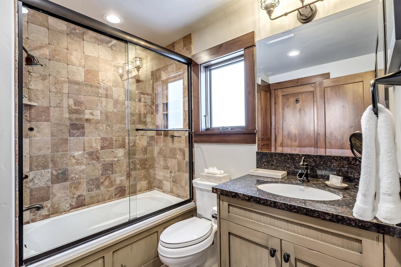 Guest full bathroom with sliding glass panel door