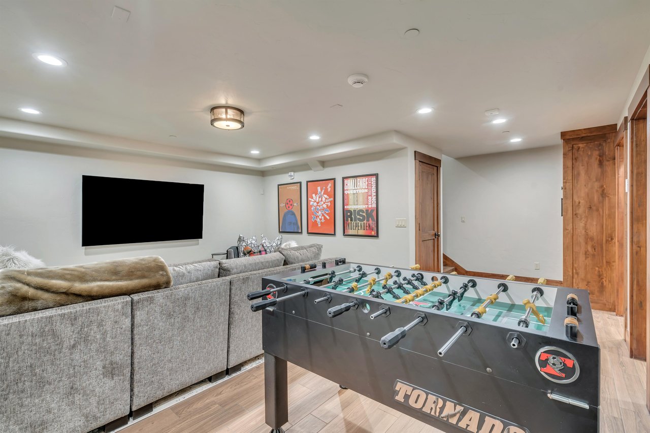 Foosball table  sits behind the sectional in the game room