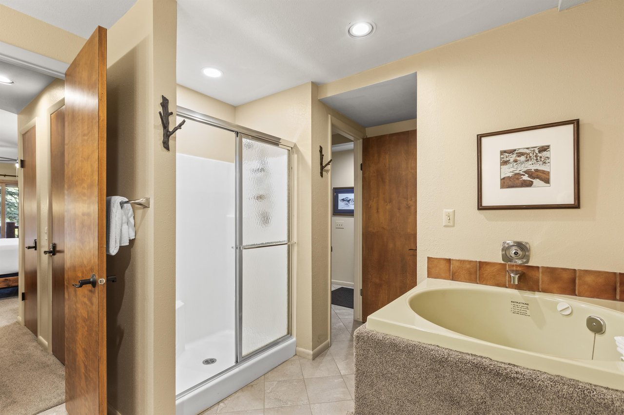 The en suite bathroom has a walkin shower and deep soaker bathtub.