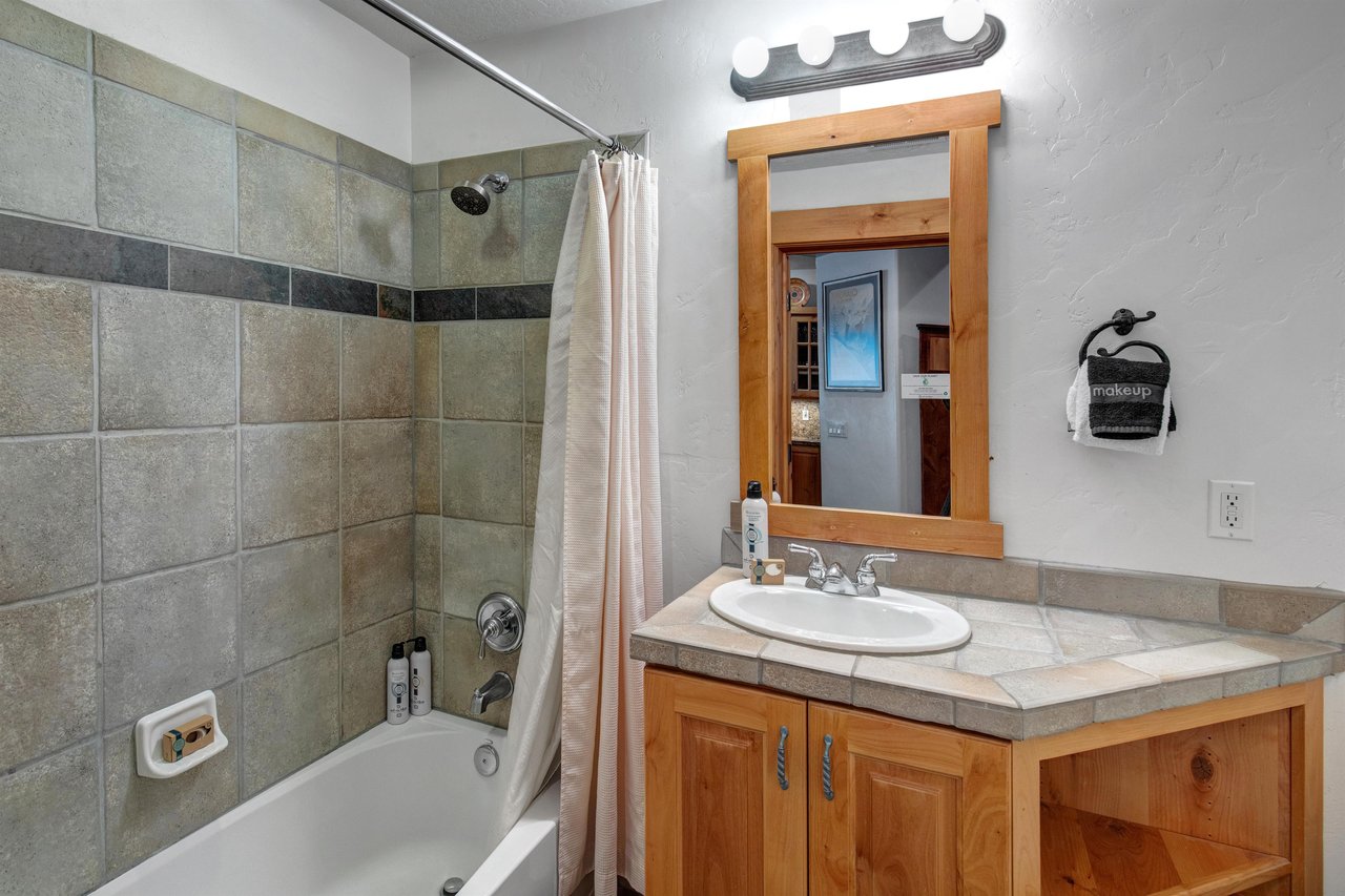 The shared bathroom with bathtub and shower combination.