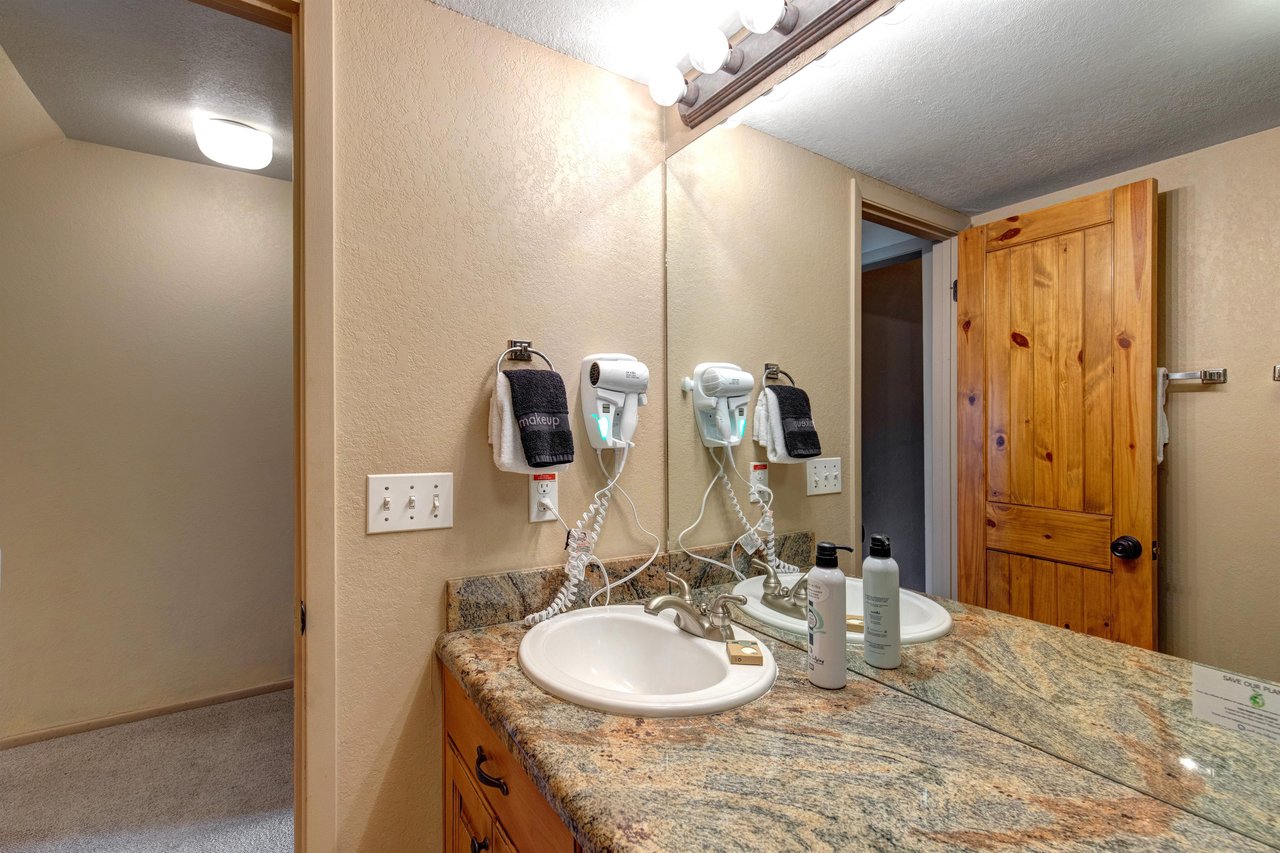 The bathroom has a two sink vanity.