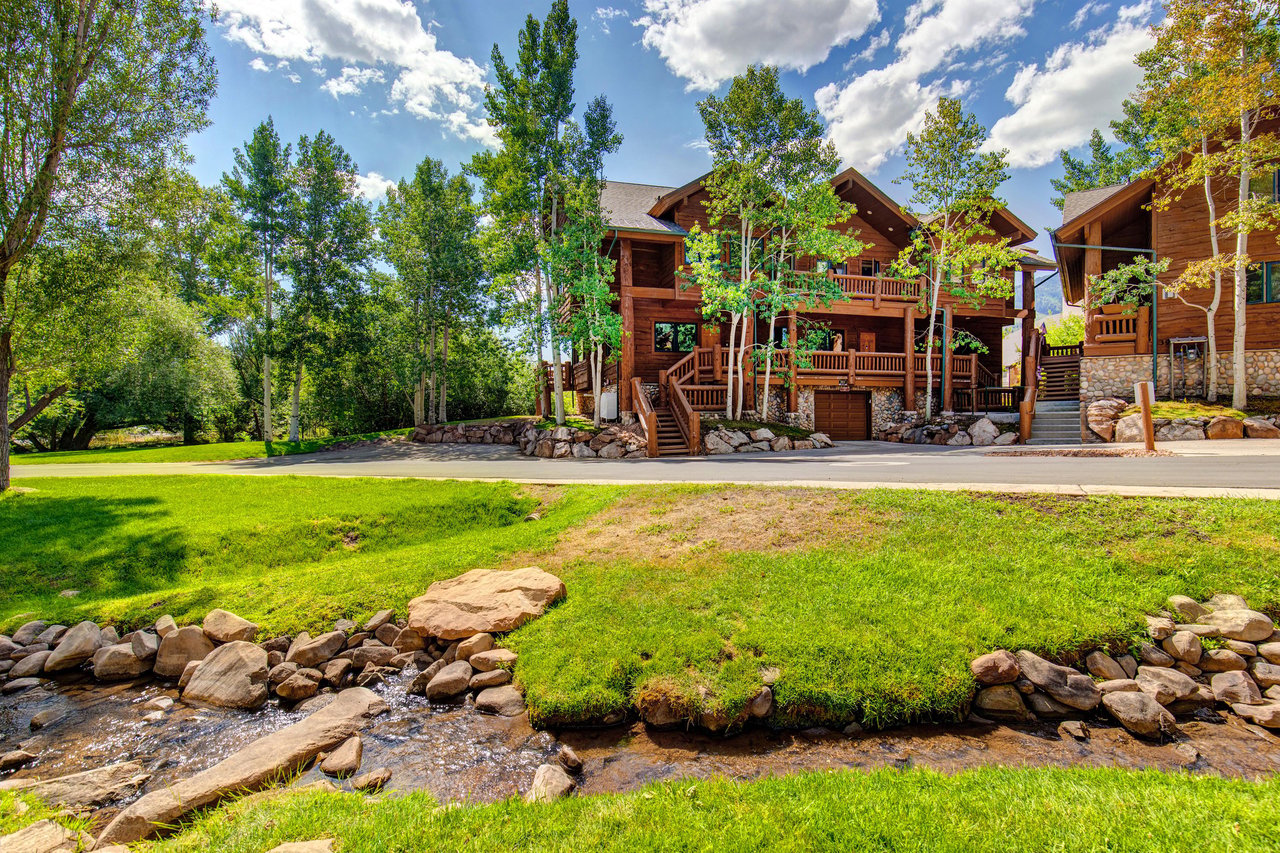 Timber Wolf Lodge 7C is surrounded by plants, trees and a babbling creek nearby.