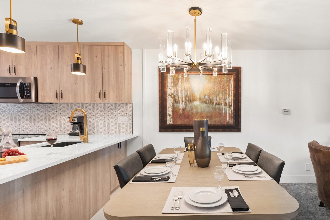 The dining table offers seating for 6 guests and has a gorgeous modern chandelier.