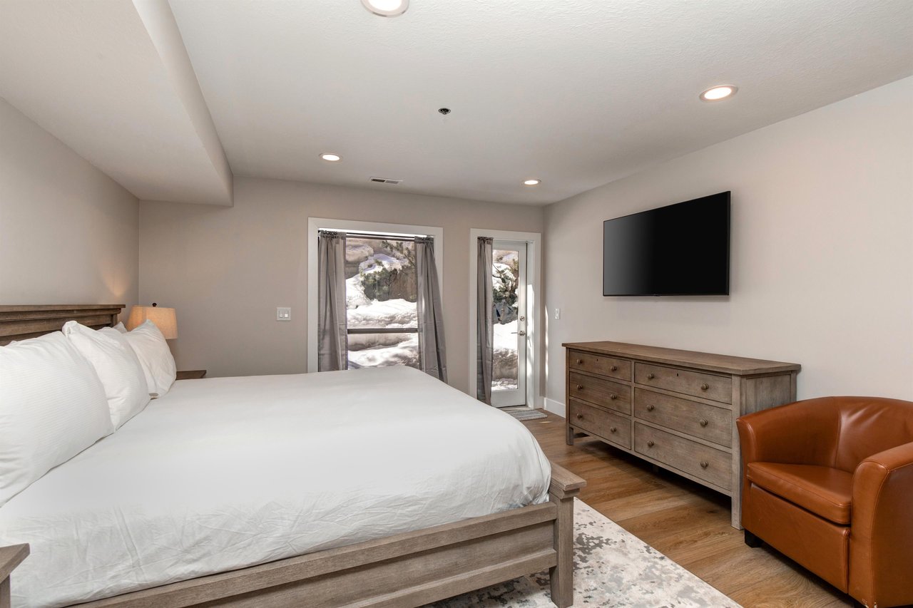 The main suite offers a king size bed, well appointed furniture, and flat screen TV..