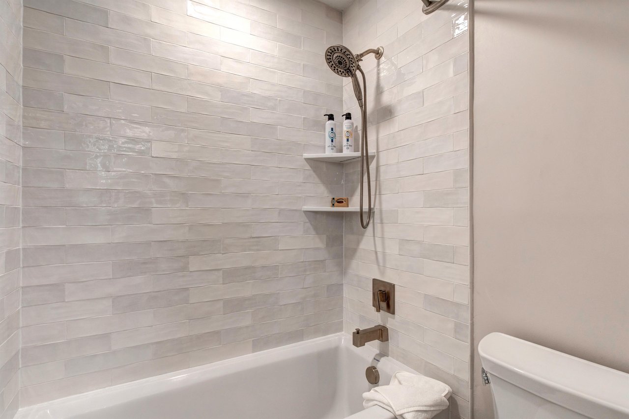 The shared bathroom offers a bathtub and shower combination.
