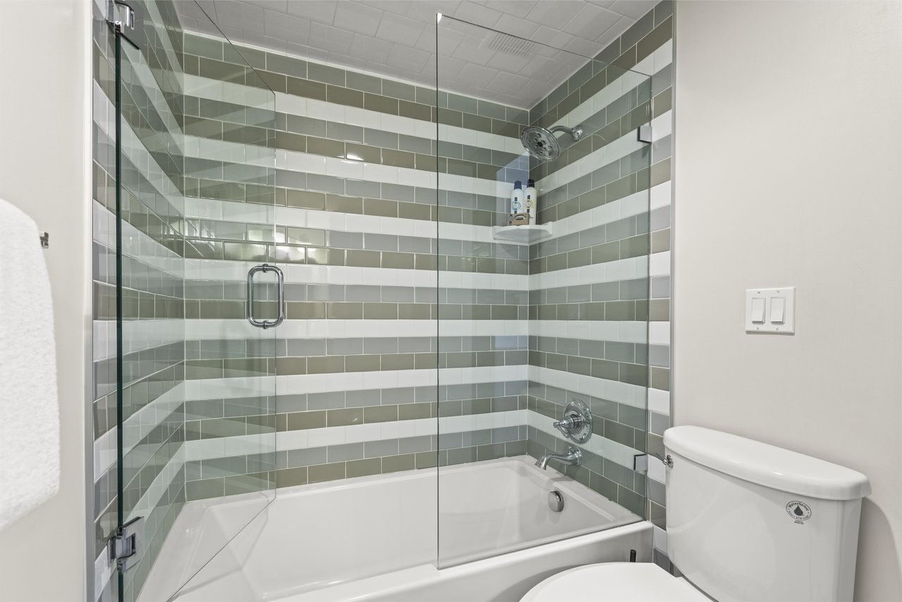 The loft has an en suite bathroom with a bathtub and shower combination.
