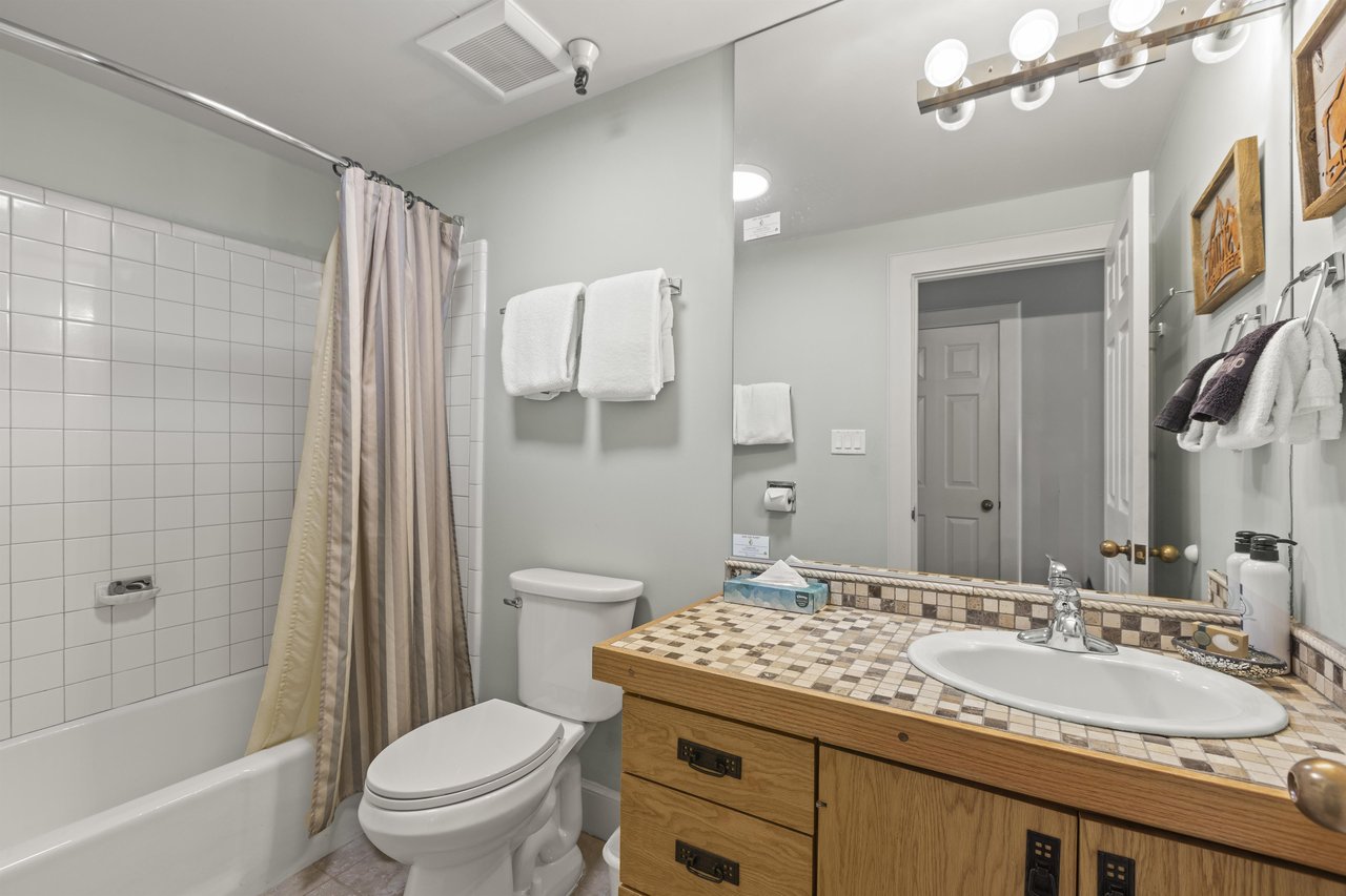 The bathroom with a bathtub and shower combination.