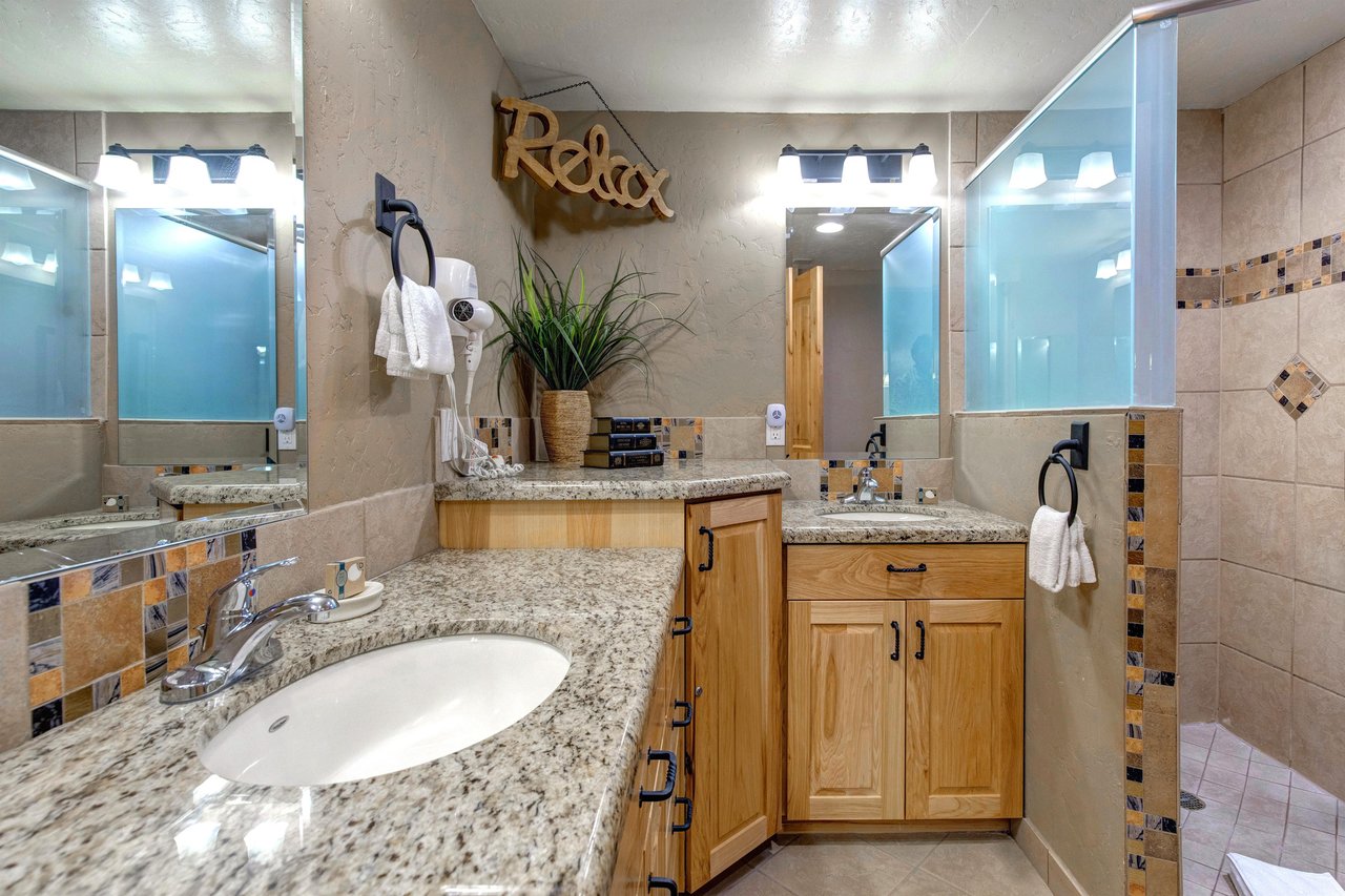 The spacious shared bathroom with 2 sink vanity.