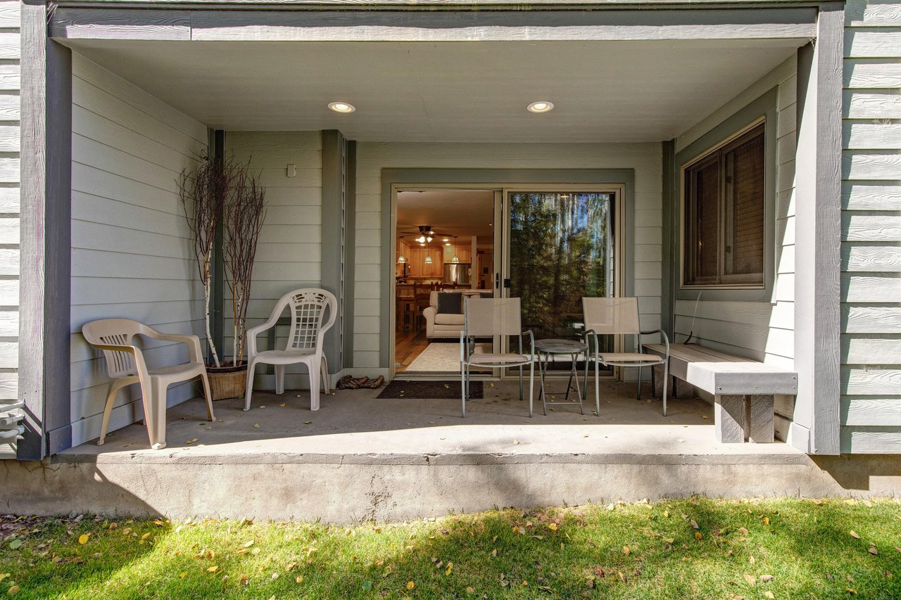 The private patio with 4 chairs and a bench.