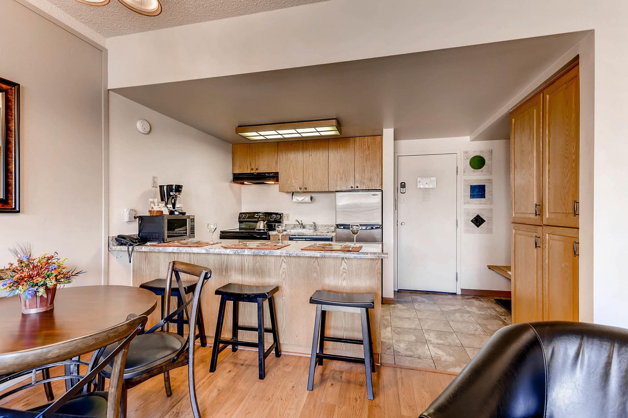 The dining area with seating for 4 guests and the breakfast bar with seating for three guests.