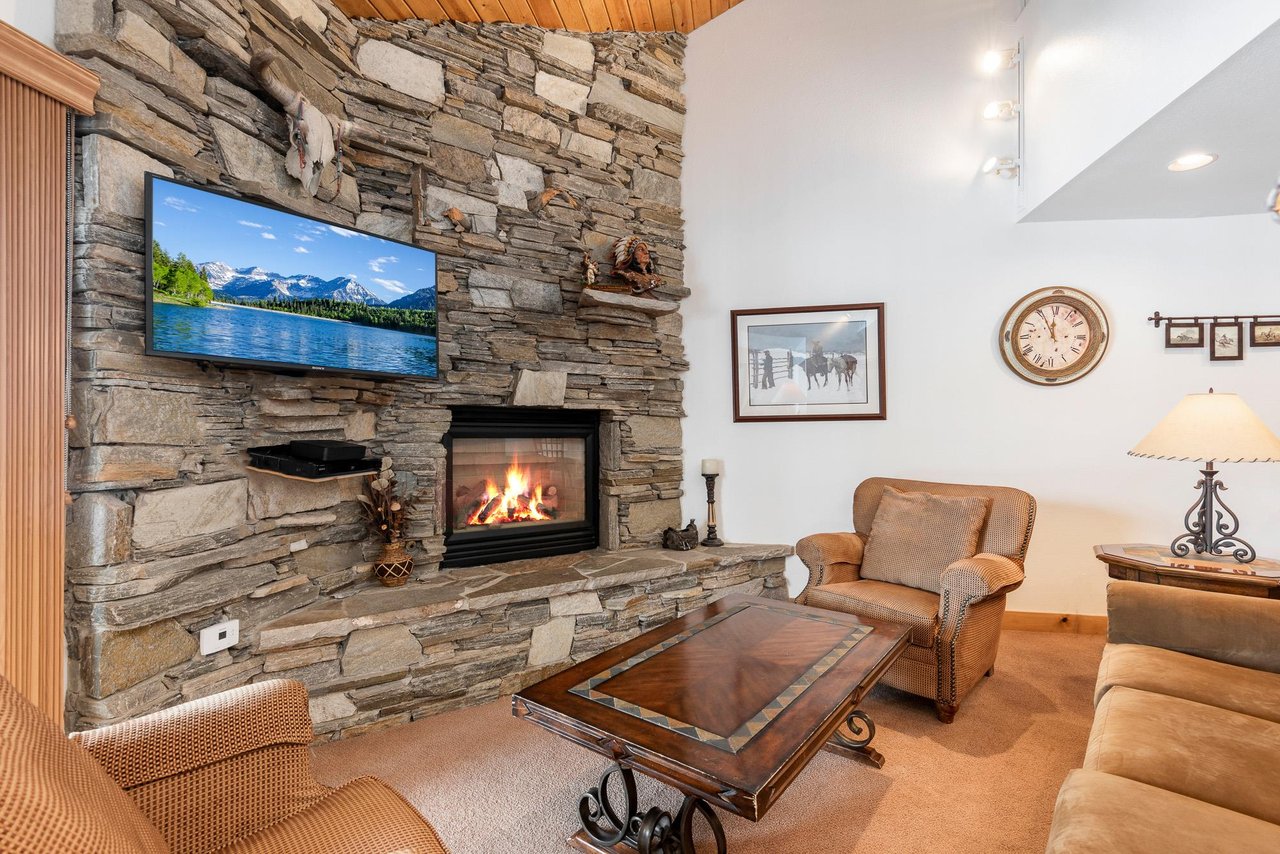 Beautiful stone fireplace, flat screen TV and cozy furnishings.