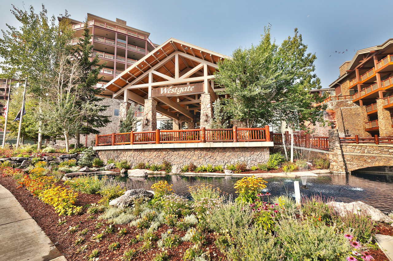 Westgate Park City exterior with water feature and wildflowers