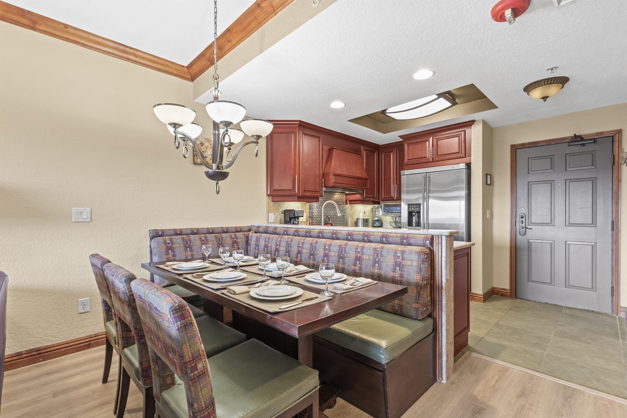 Your elegant dining area features a spacious booth and table perfect for family meals, with a fully equipped kitchen.