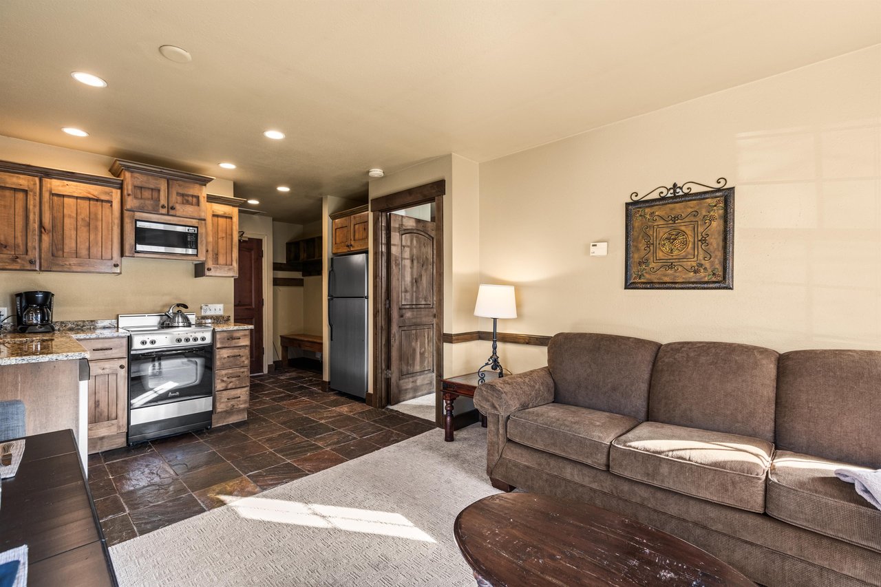 The open concept living area with efficient kitchen and dining table for two guests.