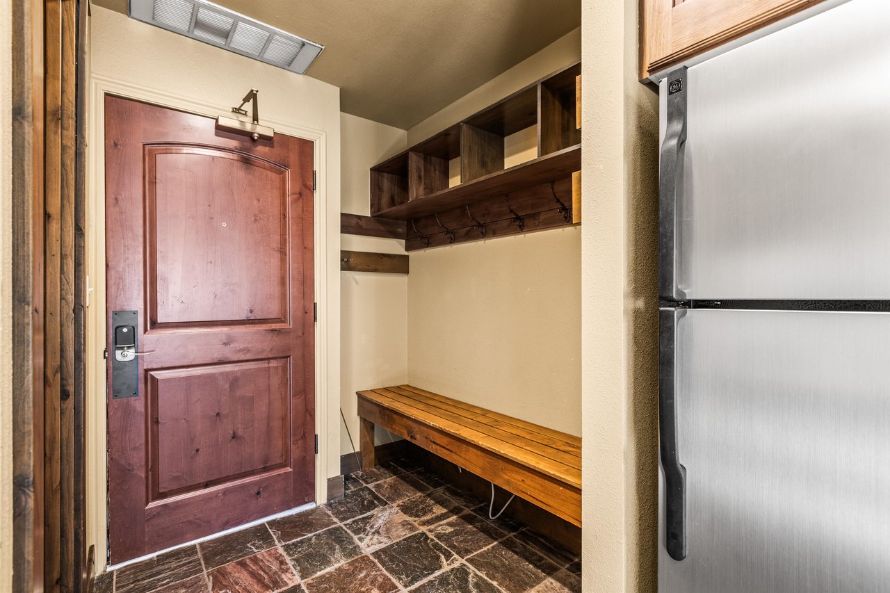 The entryway with a large bench and plenty of room for outdoor gear.