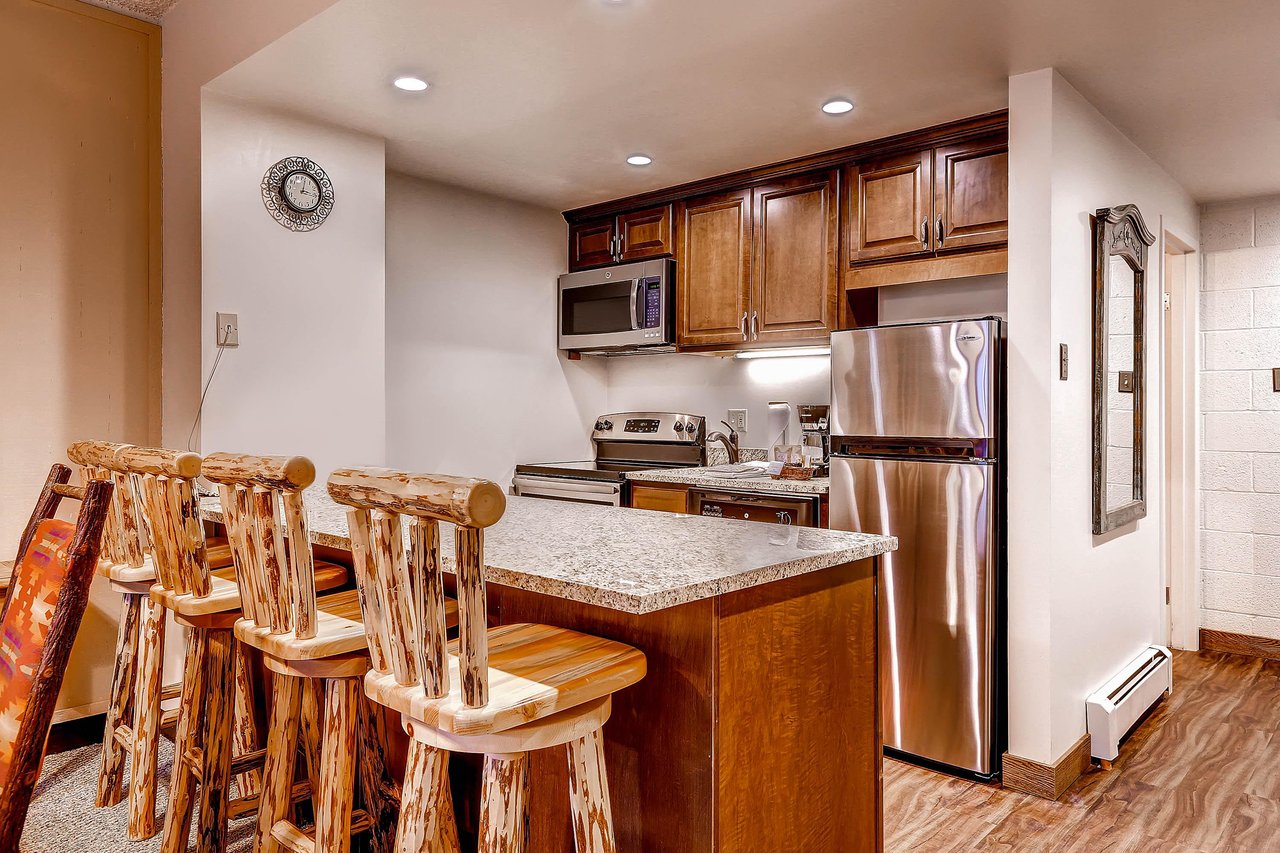 Breakfast bar seating for 4 with a full kitchen.