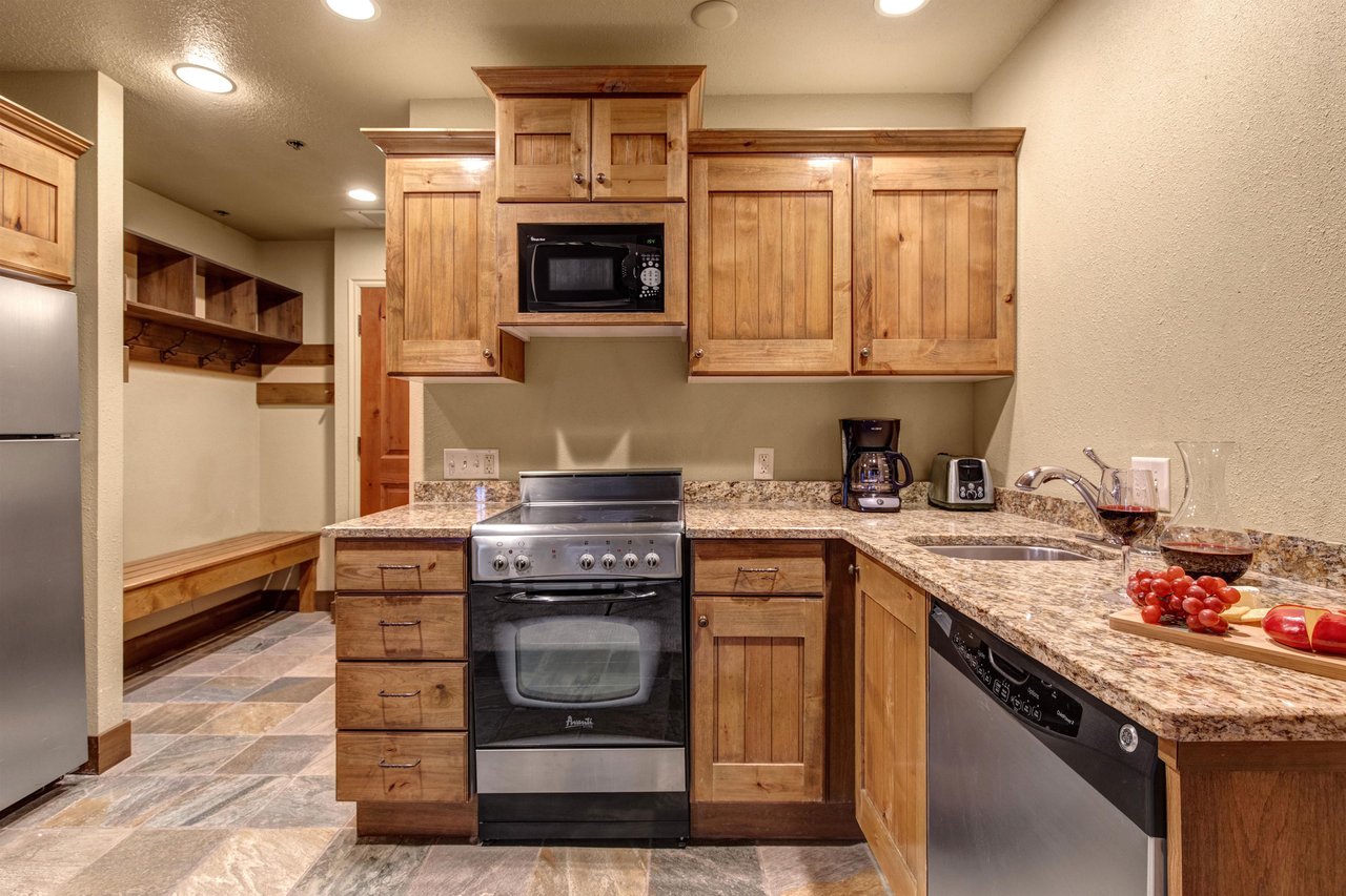 Your fullyequipped kitchen awaits with wood cabinets, granite countertops, and everything you need to create meals.