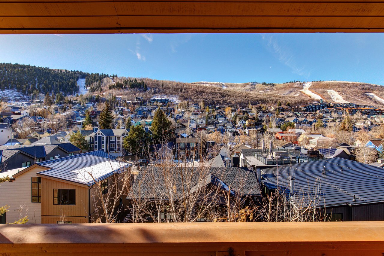Panoramic mountain town view showcasing the surrounding ski resort community and snowcapped peaks in the distance.