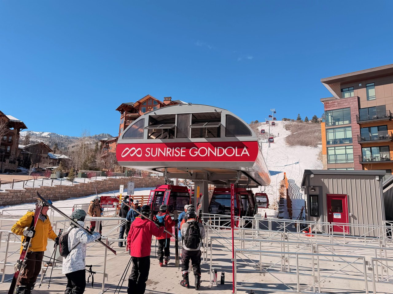 Sunrise Gondola loading area with skiers loading the lift to ski or snowboard Park City Mountain Resort.