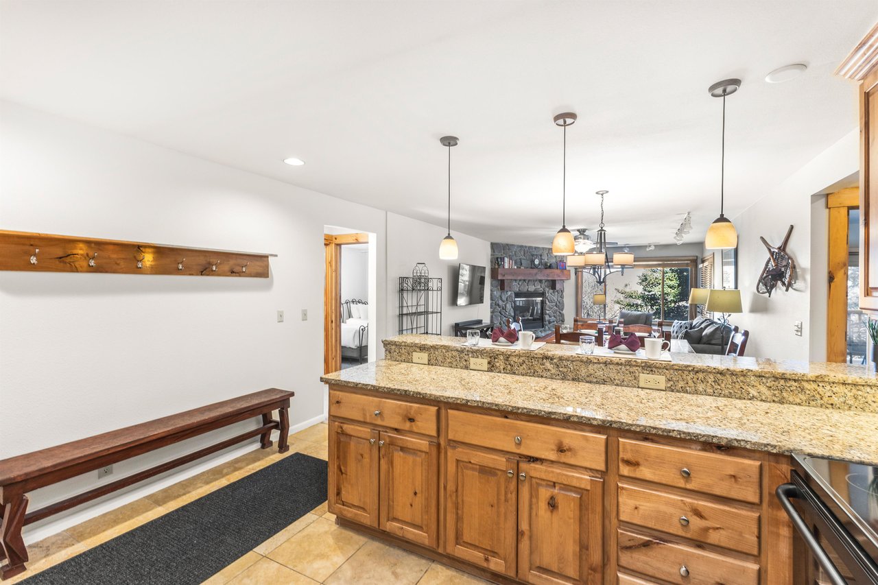Snow Flower Condominium 14s granite counters with wood cabinets, as well as several power outlets for convenience.