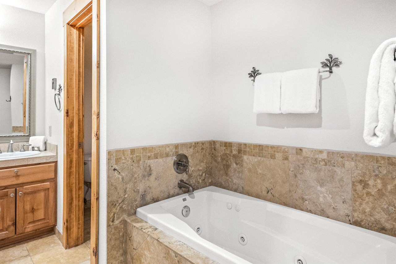 Snow Flower Condominium 14s main suites private bathroom with jetted tub.