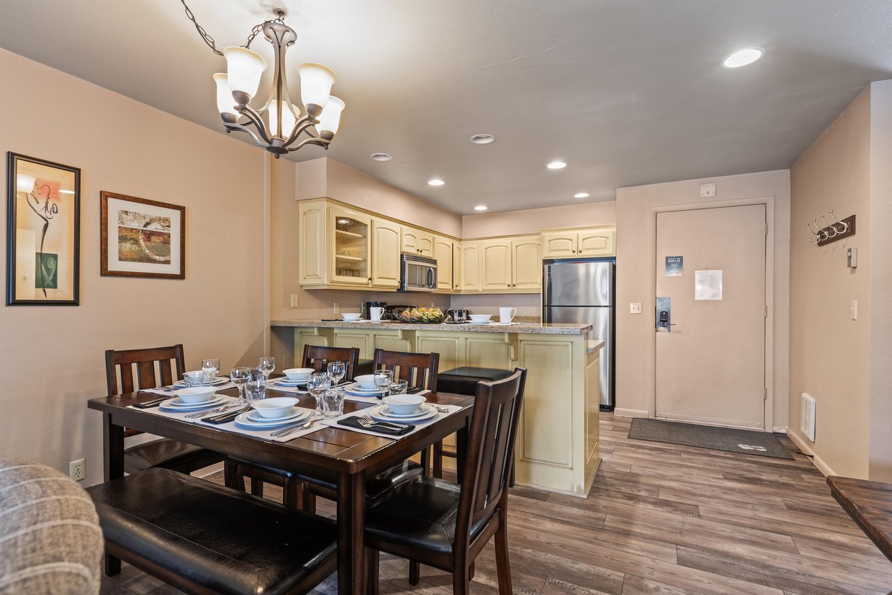 Premier Snow Flower Condominium 107s dining room for 6 next to open concept kitchen.