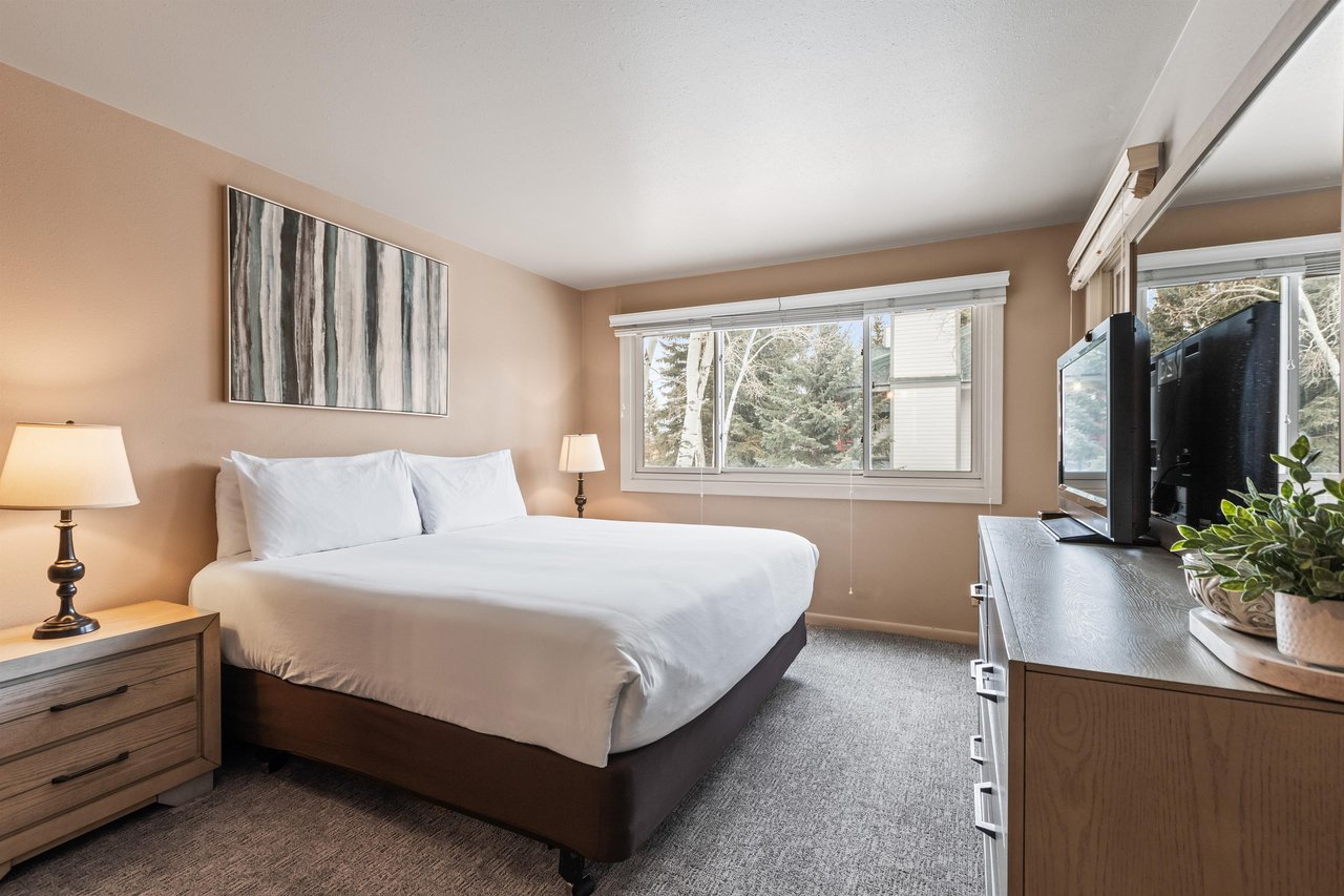 Premier Snow Flower Condominium 107s main suite with king bed and dresser.