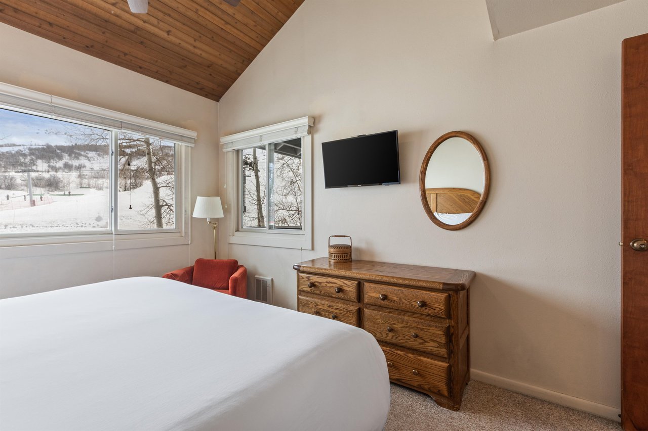 Premier Snow Flower Condominium 130s main suite flat screen TV and dresser.