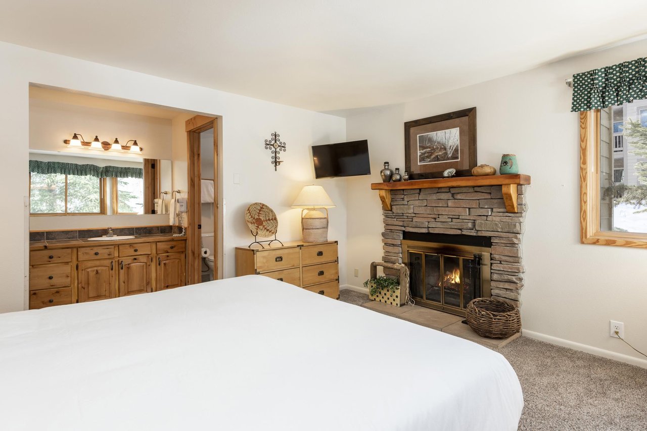 Enjoy a warming fireplace at the foot of your bed