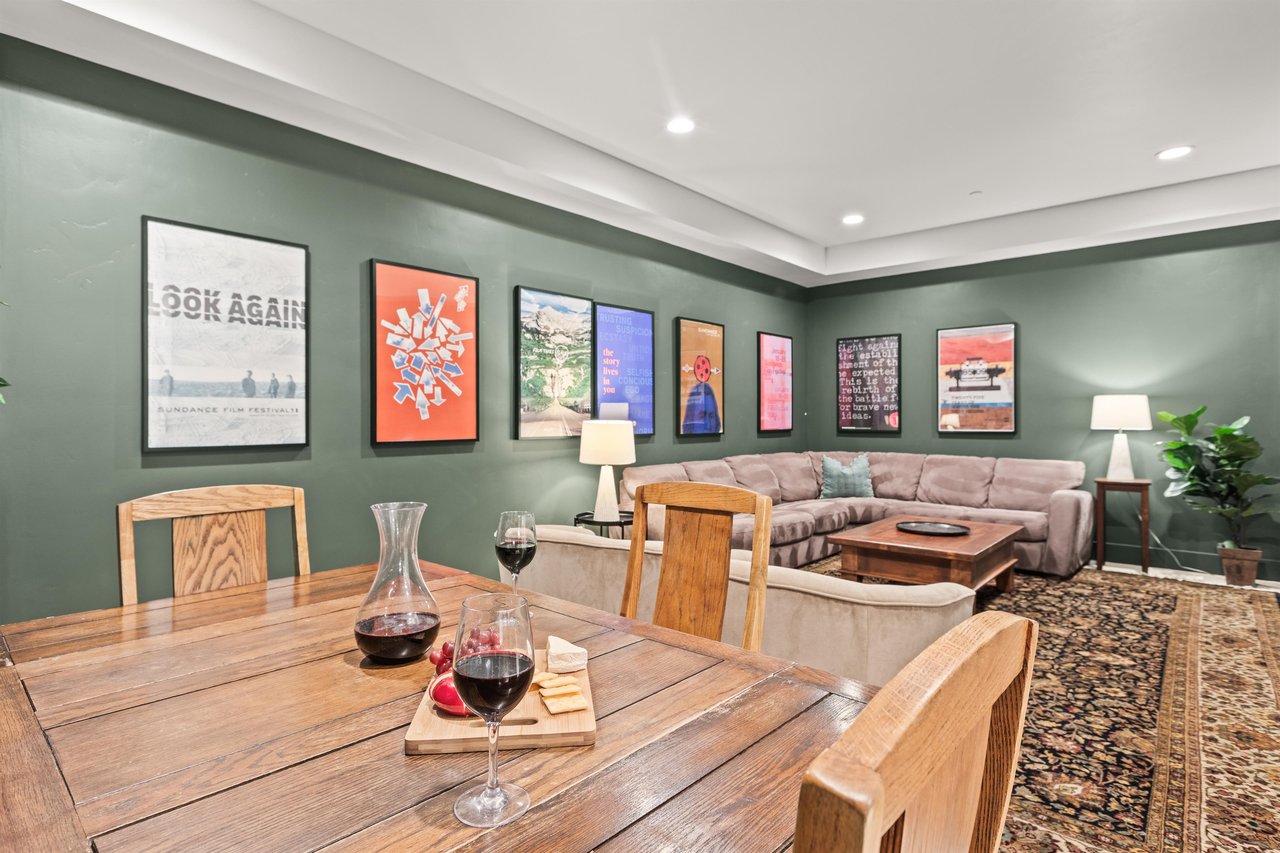 Unwind in your openconcept living space, featuring sage walls with curated artwork and a cozy sectional sofa.