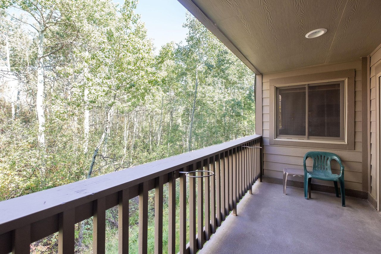 Enjoy the private patio with forest views in the summer at the Snow Flower 149 vacation rental.