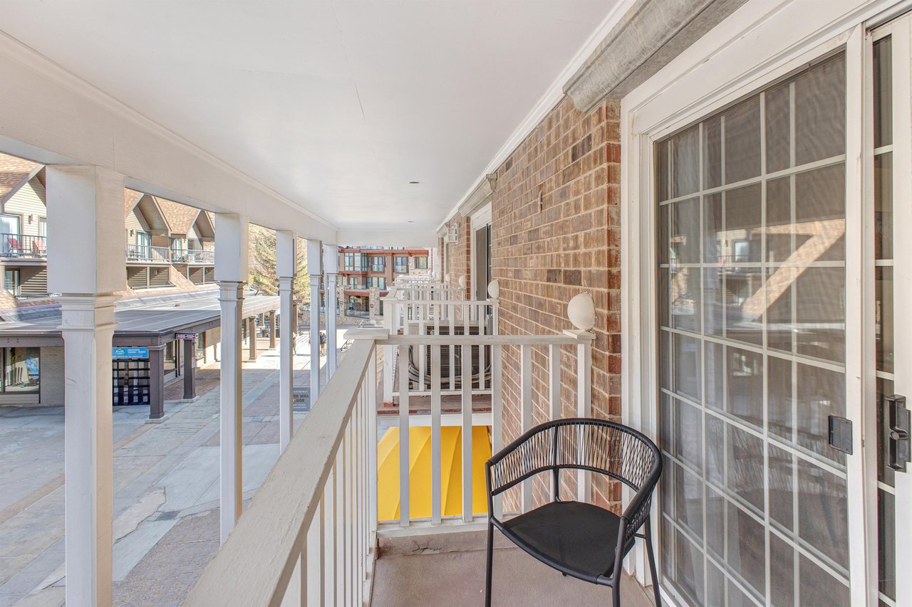 Enjoy your own private covered patio with white picket fencing overlooking the plaza.
