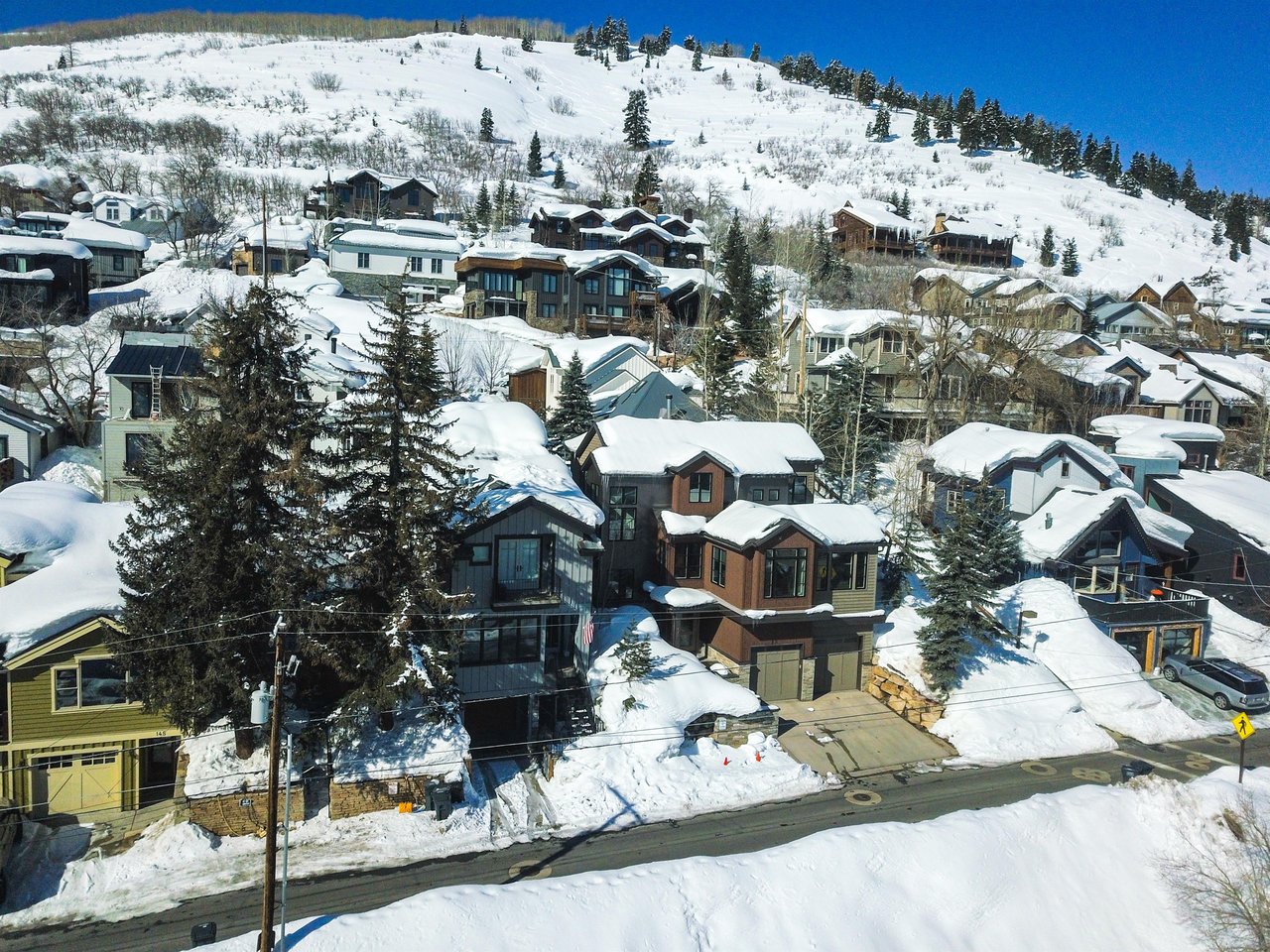 A snowy mountain and neighborhood situated behind 159 Woodside vacation rental.