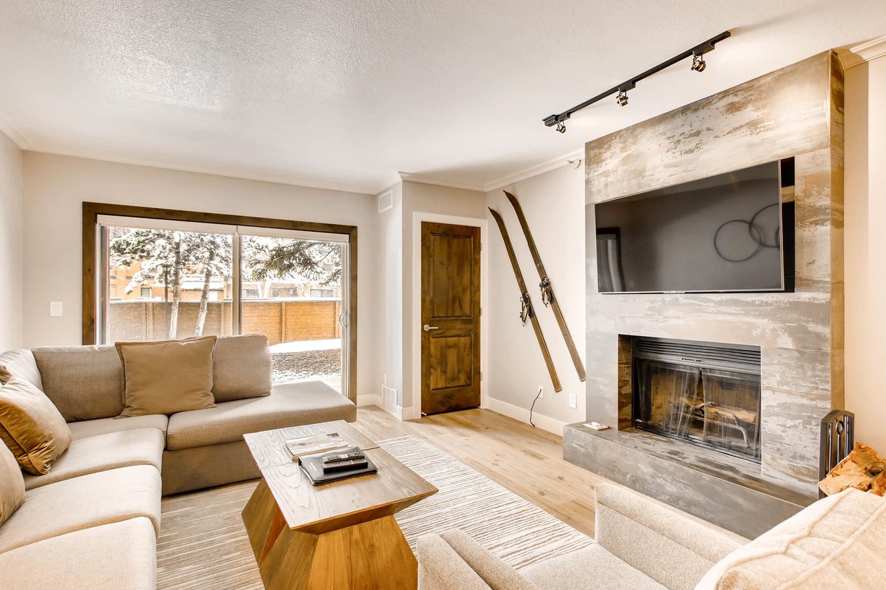 Living room space opens to the sliding glass door to patio, cozy wood burning fireplace and large screen TV
