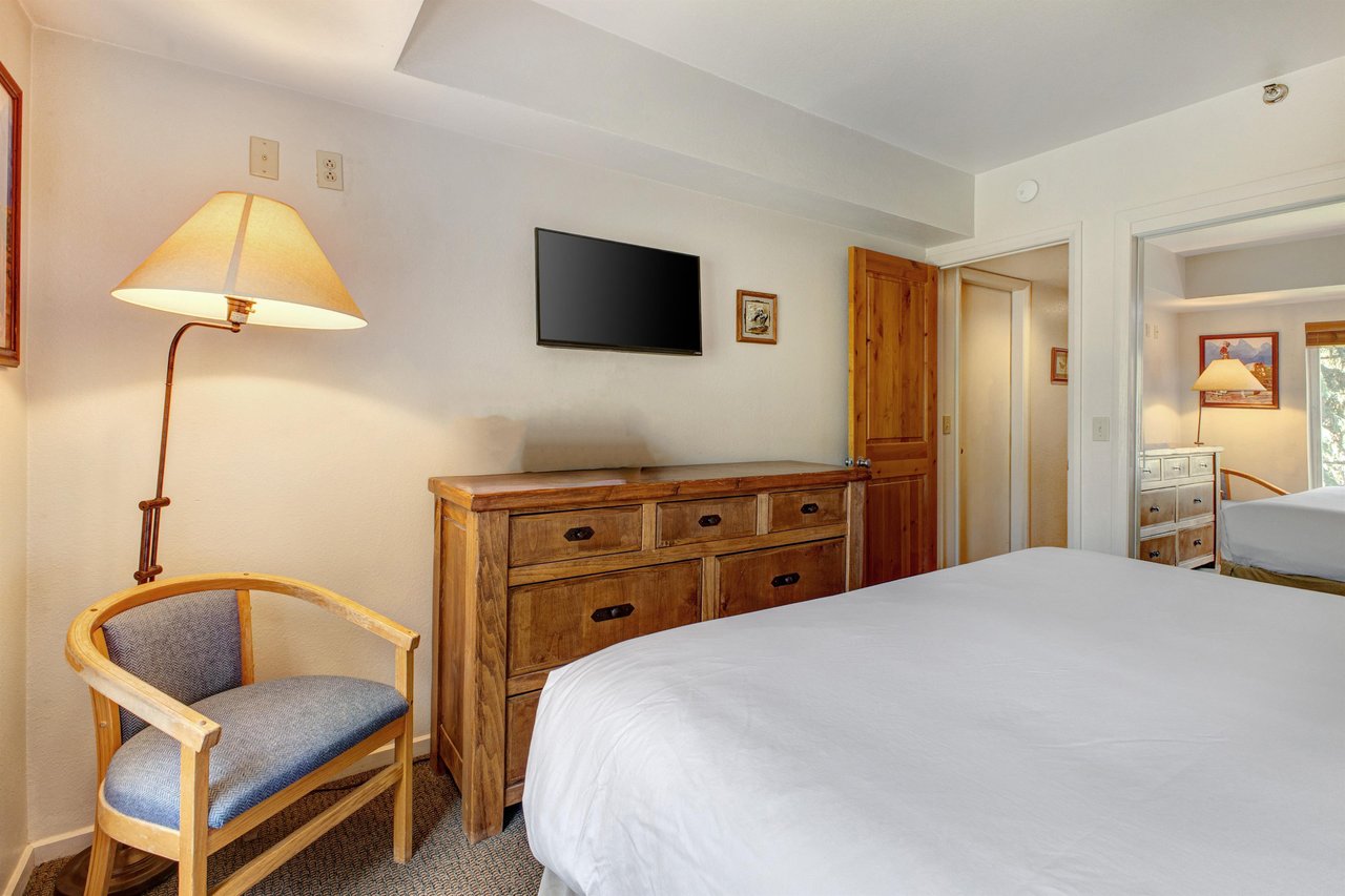 One of the bedrooms offers a kingsize bed and wood furniture.