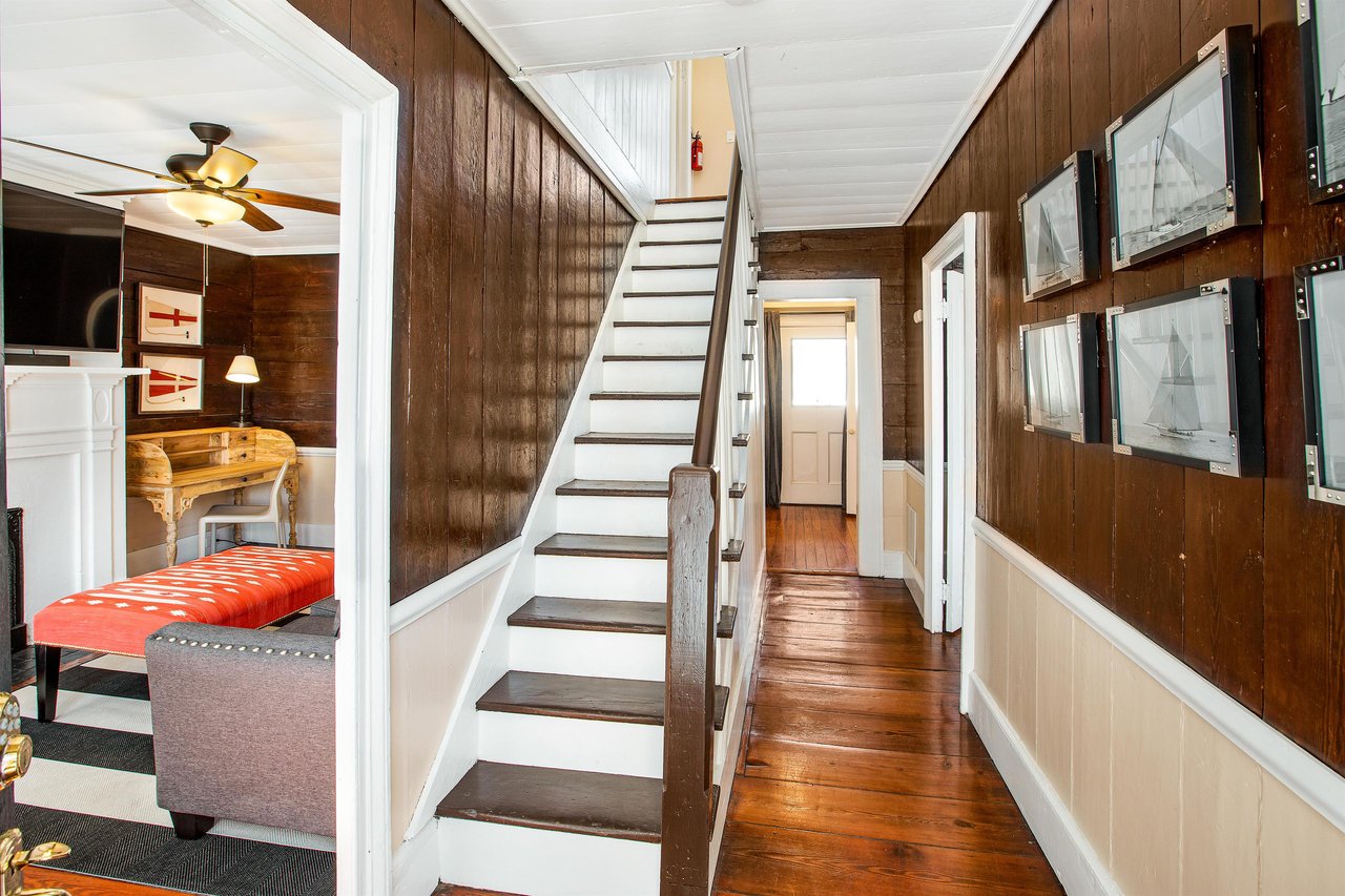 Upon entering, you are immediately greeted by original shiplap walls and hard wood floors.
