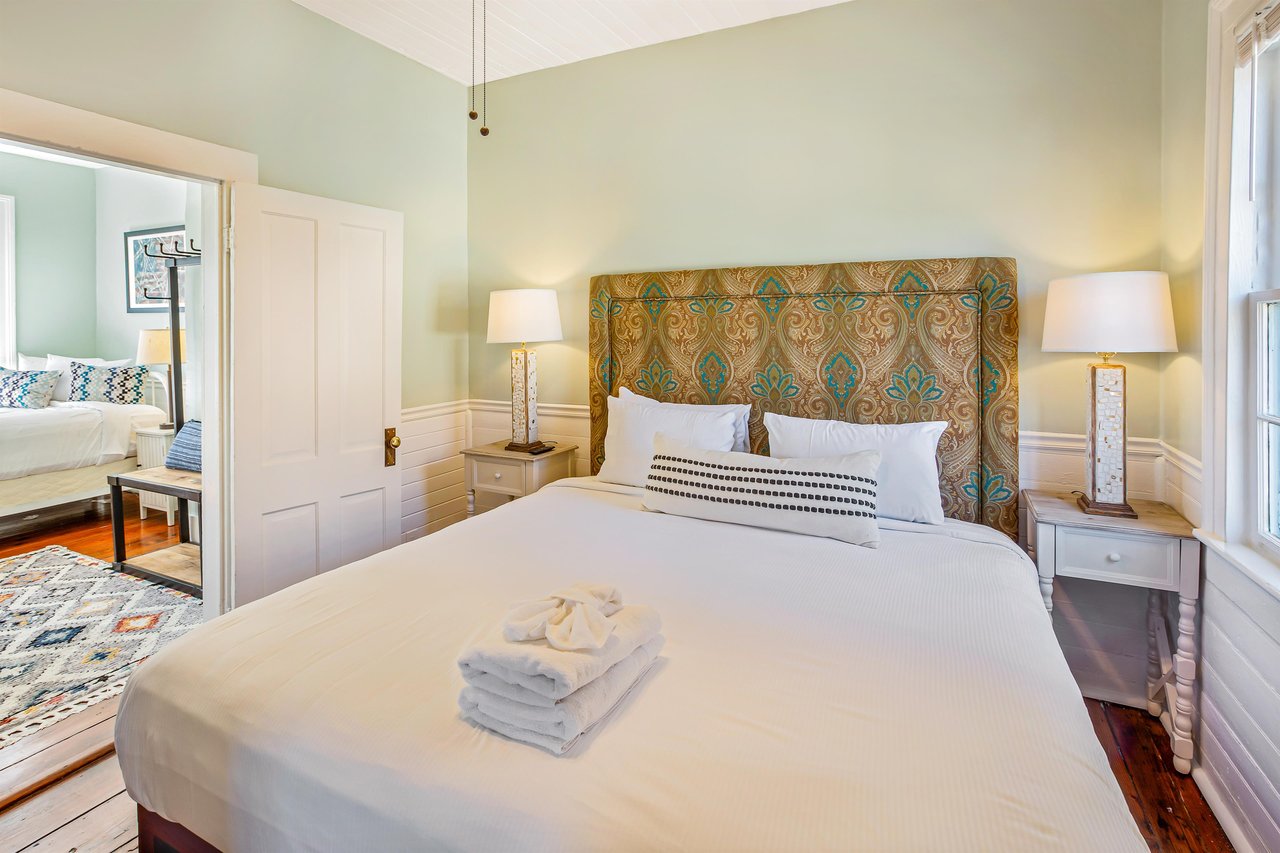 The king size bed fits perfectly in this quaint room, with two matching night stands.