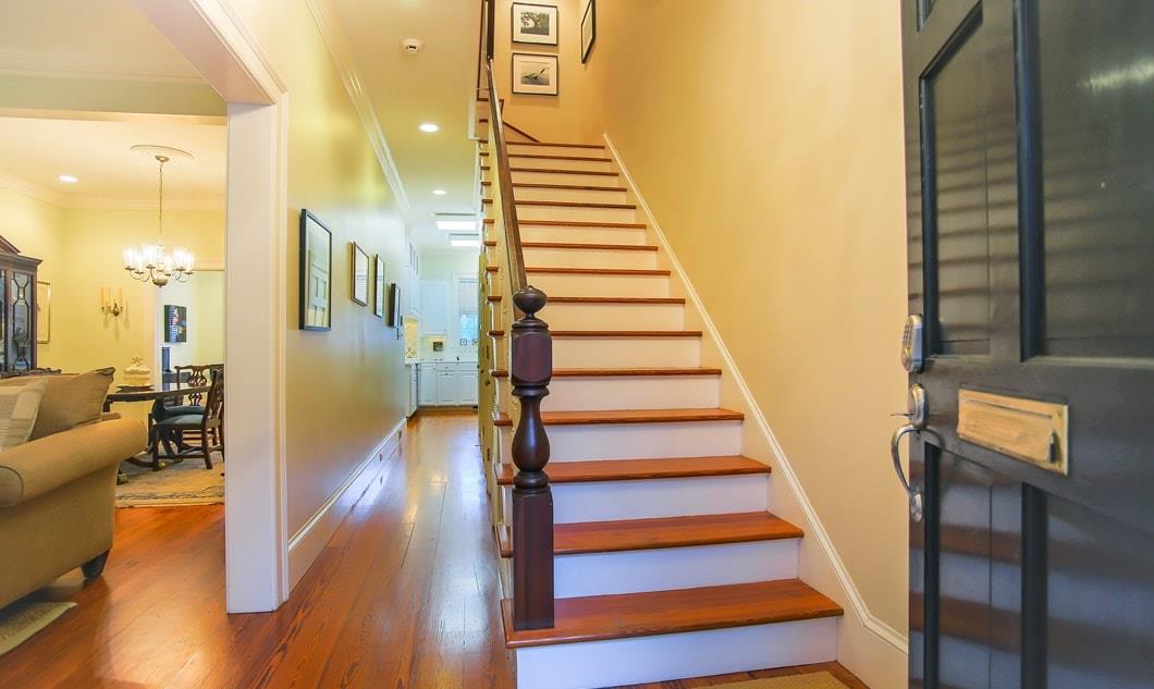 The entry to the townhome leads to a grand staircase on the right, and formal living and dining room on the left.