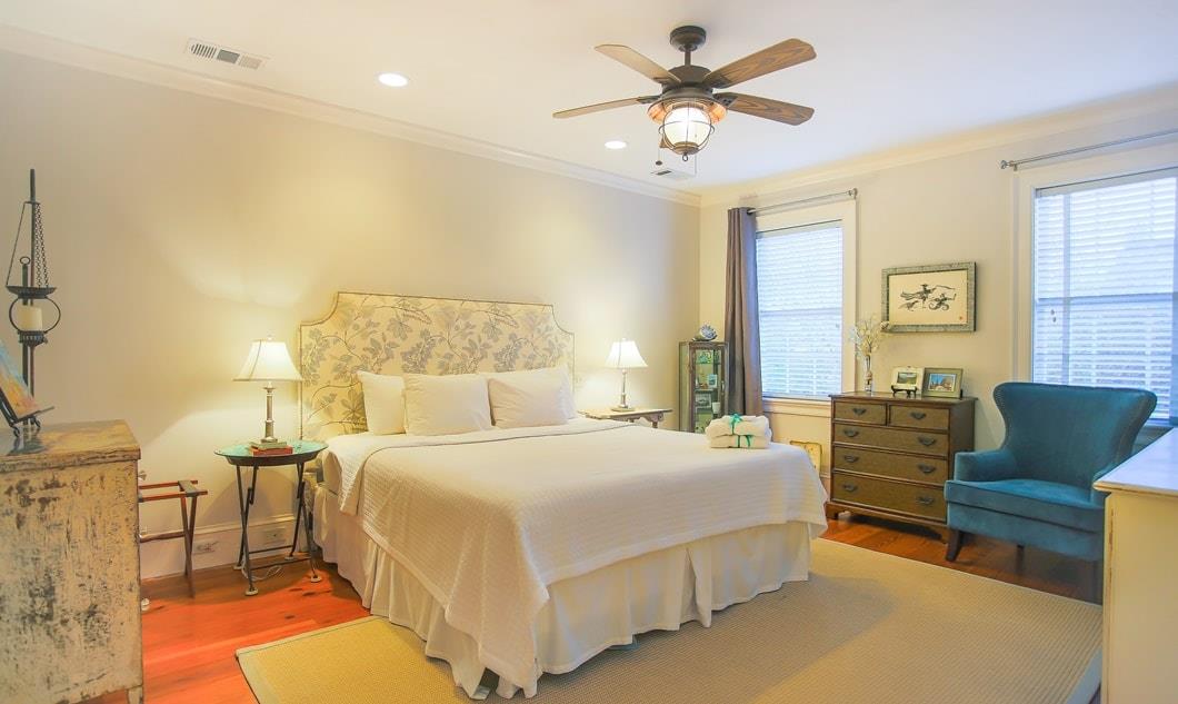 On the second floor, there are two beautiful bedrooms. This room features a king bed and ensuite bath as well as a view of the courtyard.