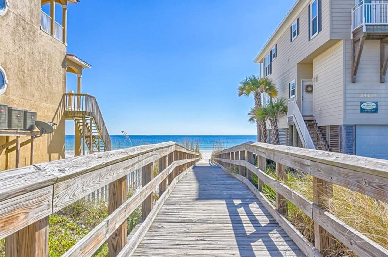 A wooden boardwalk leading to the beach at Sescape in Orange Beach Alabama