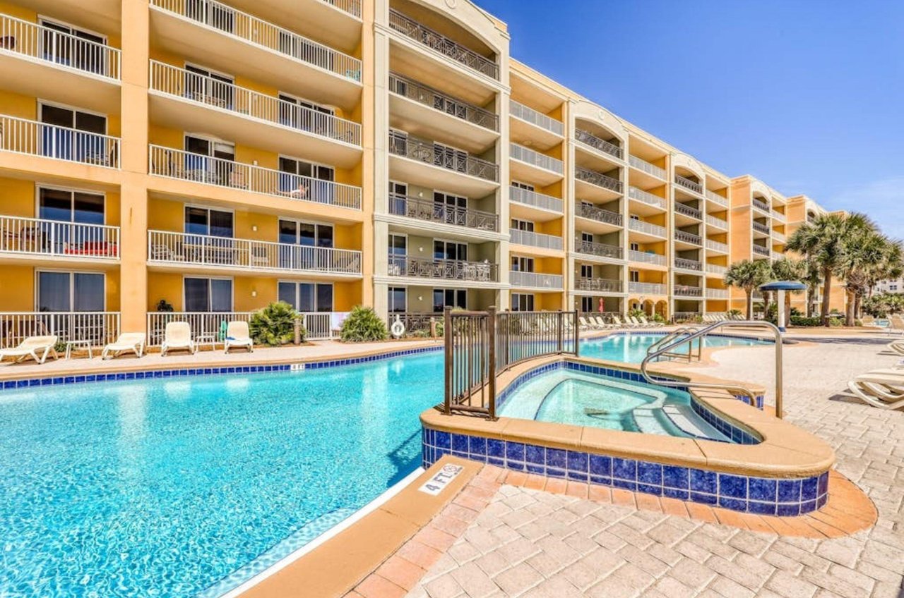 An outdoor hot tub and swimming pool next to Azure condominiums
