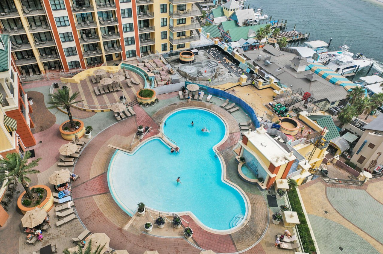 Emerald Grandes swimming pool, expansive sundeck, lounge, and play areas seen from a balcony.