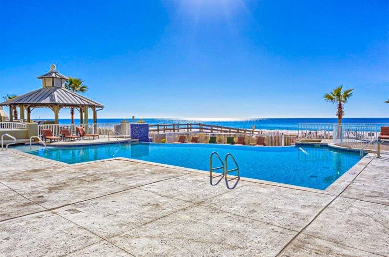 The outdoor swimming pool next to the beach at Escapes to the Shores in Orange Beach Alabama