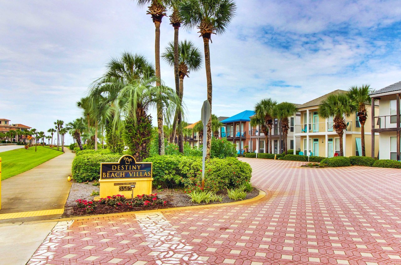 Destiny Beach Villas distinctive tropical landscaping, towering palm trees, tile roads, and individual villas add up to a quaint village feeling.
