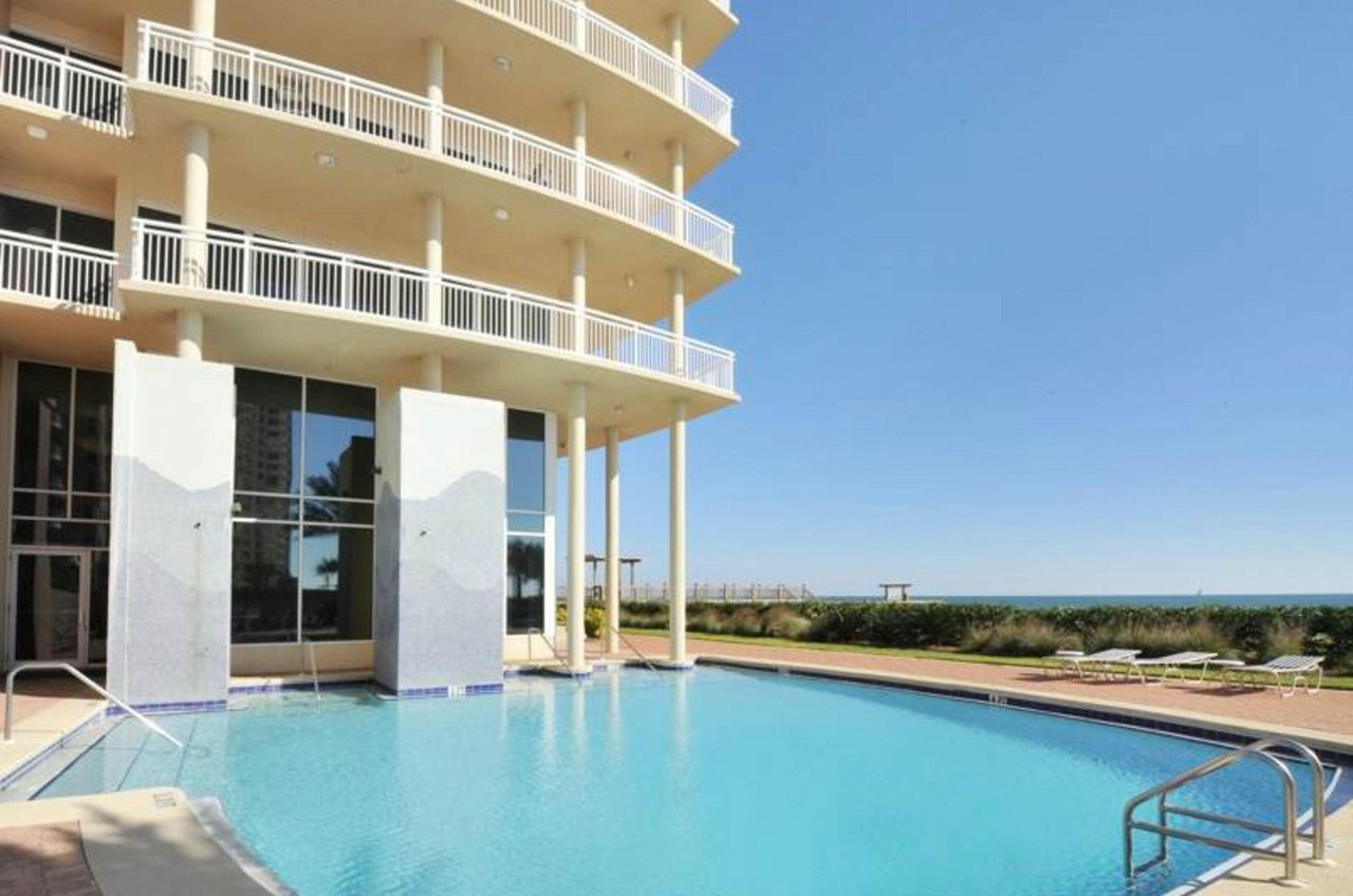 The beachfront and outdoor swimming pool next to La Playa Condos