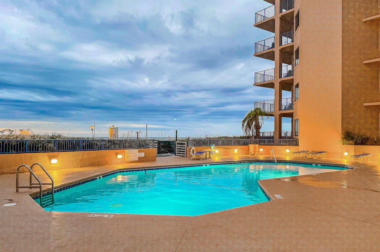 The outdoor swimming pool lit up at night at Four Seasons in Orange Beach Alabama