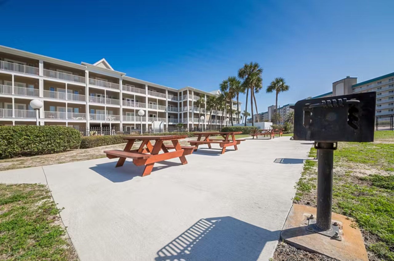 Outdoor patio with picnic tables and barbecue grills