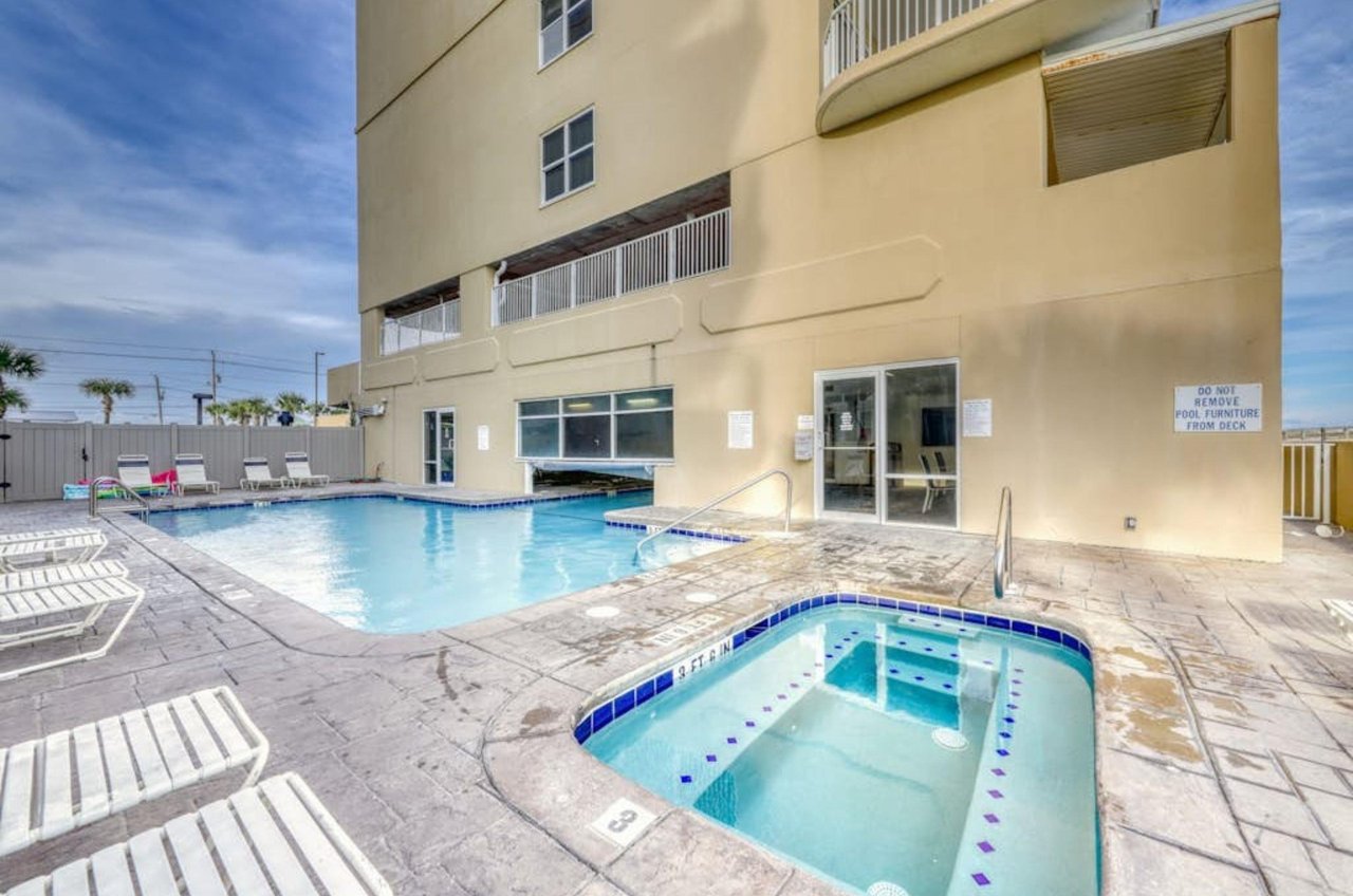 The indooroutdoor pool and outdoor hot tub in front of Island Royale in Gulf Shores Alabama