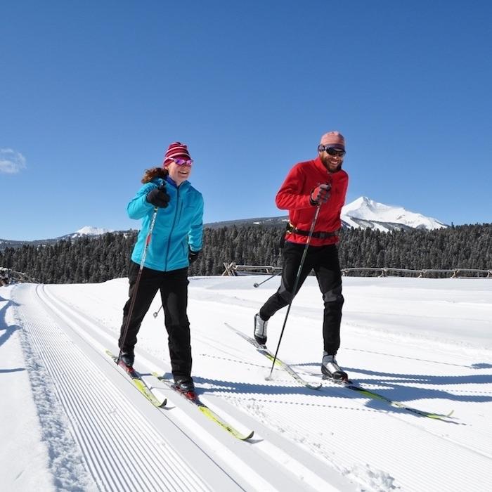 25 A Man And Woman On Skis