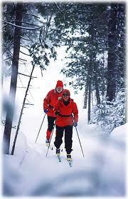 26 A Couple Of People Skiing Down A Snowy Slope